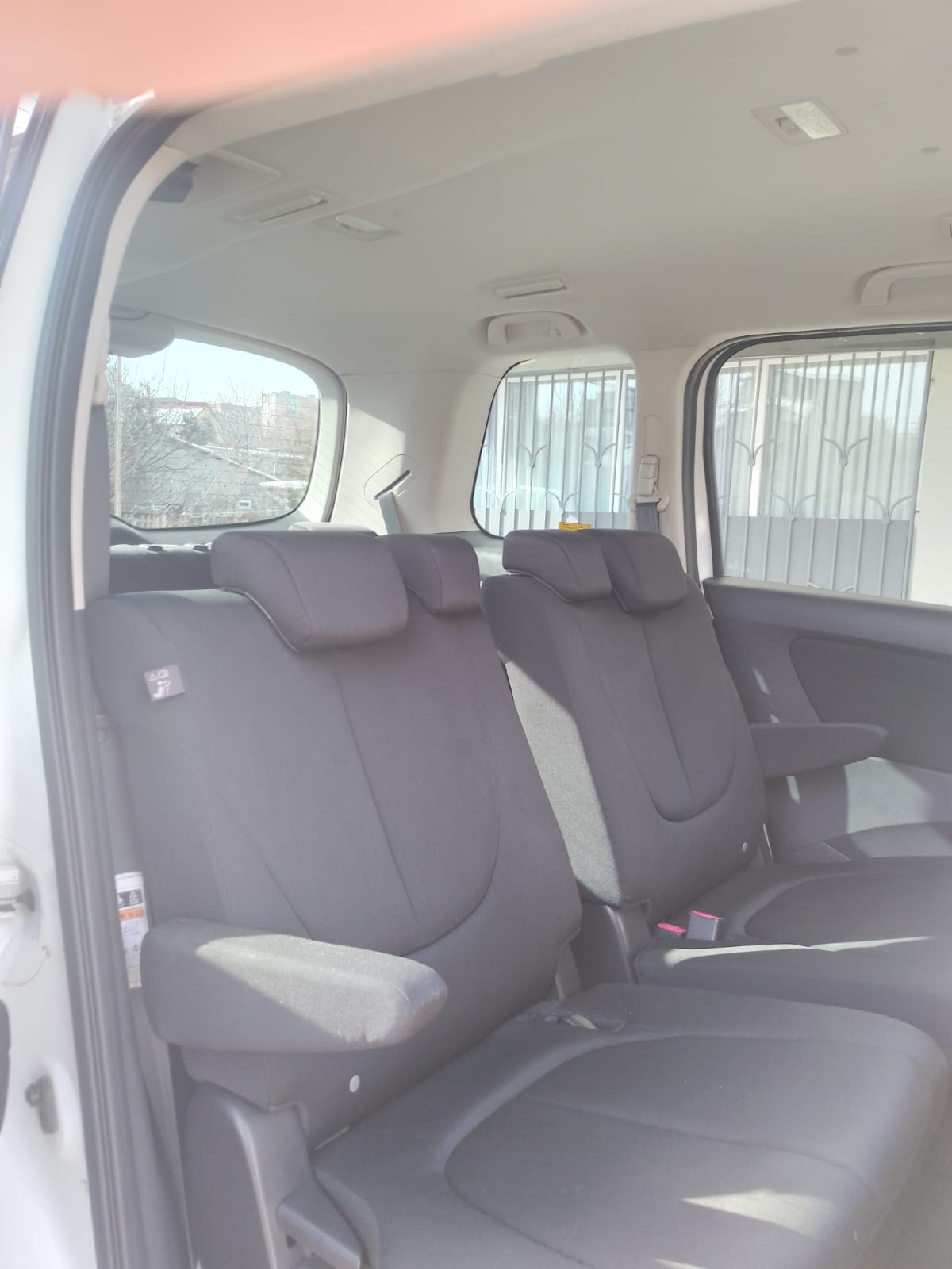 Rear passenger seats inside the Mazda minivan