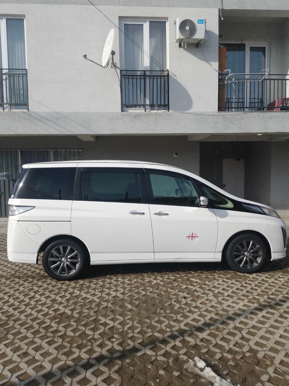 Side view of the white Mazda minivan